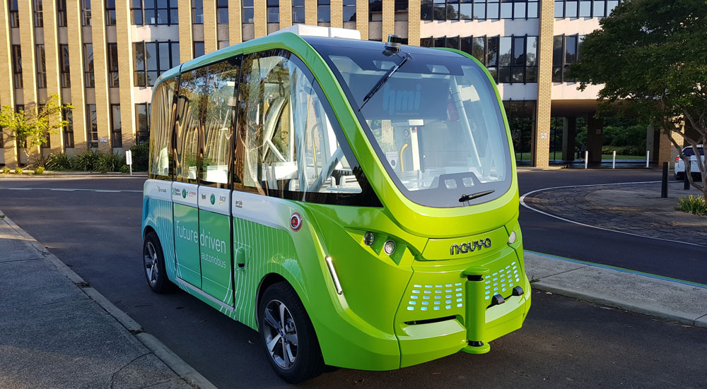 Image of an automated shuttle in a university setting.