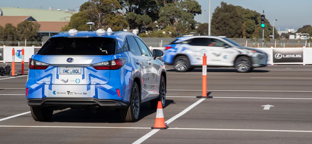 An image of two vehicles on a test track intersection.